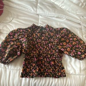 Black floral smocked blouse from H and M.